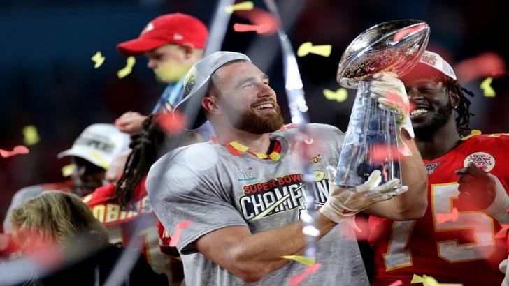 Travis Kelce holds the Vince Lombardi Trophy